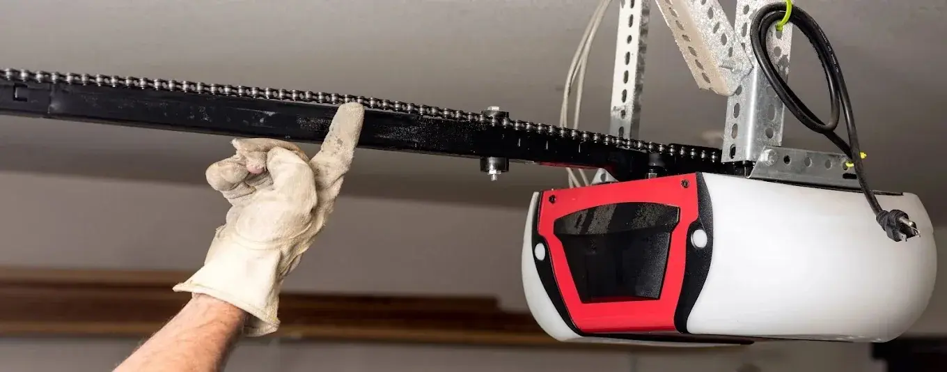 Garage door chain-drive opener and overhead rail during service