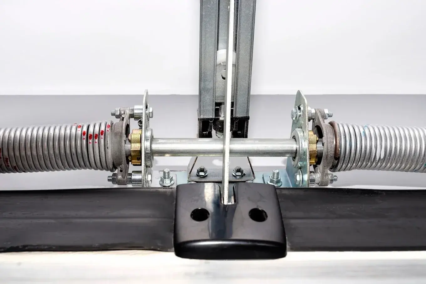 Close-up of garage door torsion springs and center bearing bracket