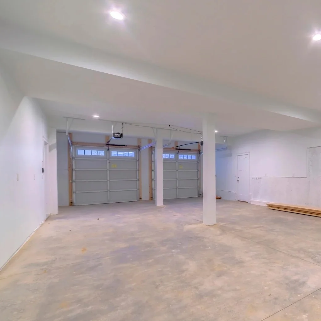 Large basement garage with two garage doors and finished ceiling lights