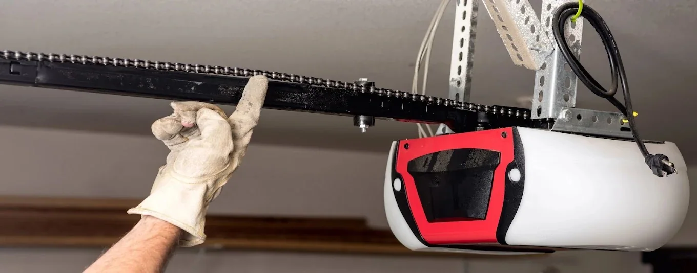 Garage door chain-drive opener and overhead rail during service