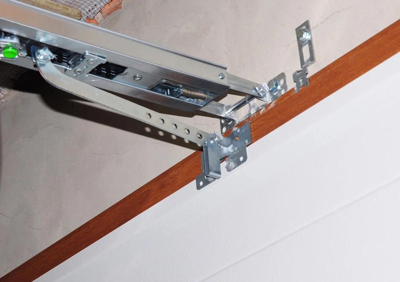 Close-up of garage door opener arm and bracket hardware