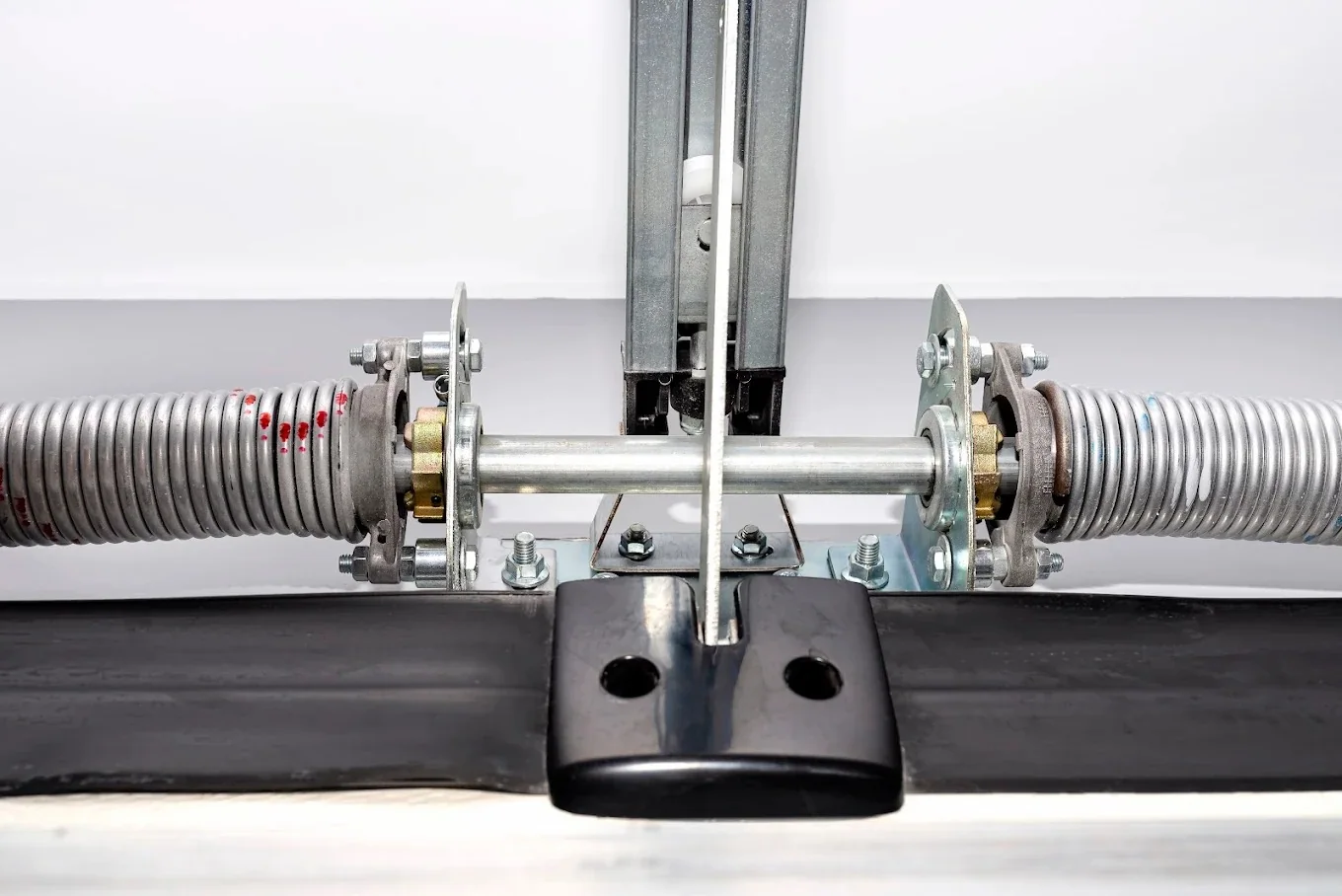 Close-up of garage door torsion springs and center bearing bracket